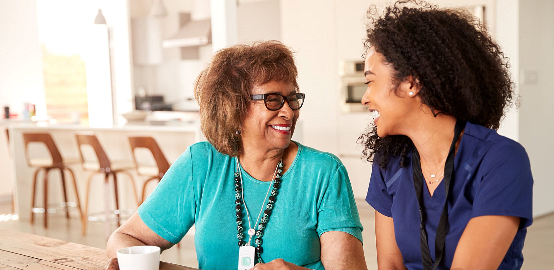 caregiver and senior drinking coffee